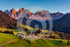 Santa Maddalena (Santa Magdalena) village with magical Dolomites mountains in background, Val di Funes valley, Trentino Alto Adige photo