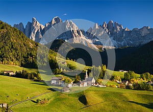 Santa Maddalena. Val di Funes. Dolomite Alps. Italy. The mountains and the forest before sunset. Natural landscape in the summerti