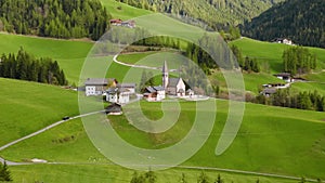 Santa Magdalena village with church in Dolomites mountains, Val Di Funes, Trentino Alto Adige, Italy. Alpine meadow in