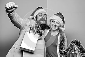 santa man and woman with tinsel. christmas shopping sales. winter holidays celebrate together. happy new year party