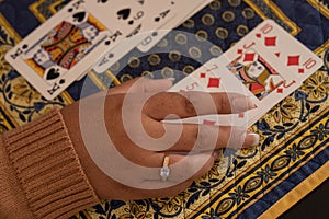 Woman playing cards at home