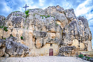 Santa Maria De Idris catholic church in rock with big cross in historical centre of old ancient town Sassi di Matera