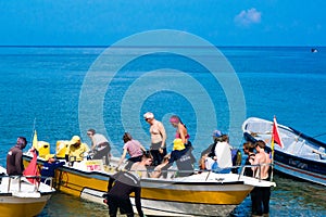 SANTA MARTA, COLOMBIA - OCTOBER 10, 2017: Unidentified tourists sailing in a boat in a caribean beach. Taganga, Colombia