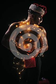 Santa with muscular body in garland