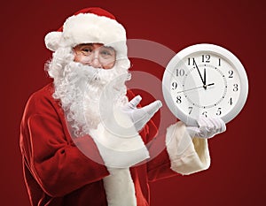 Santa pointing at clock showing five minutes to midnight