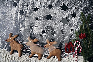 Santa reindeers made of gingerbread cookie on a winter background