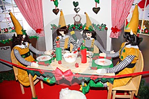 The Santa`s elves are at the dinner table