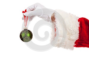 Santa's hand holding a green Christmas ornament