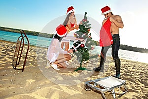 Santa's helper and Santa at the tropical beach