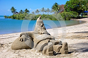 Santa sandcastle figure on beach