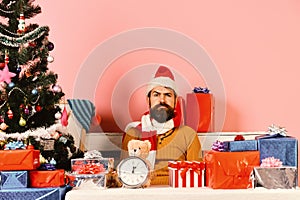 Santa sits in holiday entourage. Christmas eve and time concept