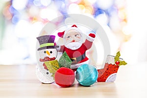 Santa with Snowman and red sock over blurred bright colorful bokeh background