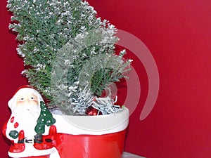 Santa standing by a xmas tree photo