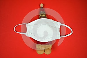 Santa toy in protective face mask. Christmas and New Year holidays during quarantine. Close up, top view