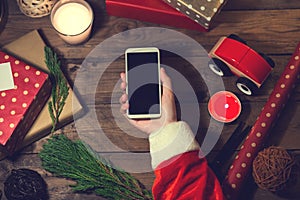 Santa use smart phone mock up with a copyspace for Christmas.