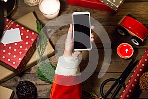 Santa use smart phone mock up with a copyspace for Christmas.
