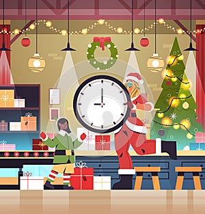 Santa woman holding clock girl elf putting gifts on conveyor new year christmas holidays celebration concept