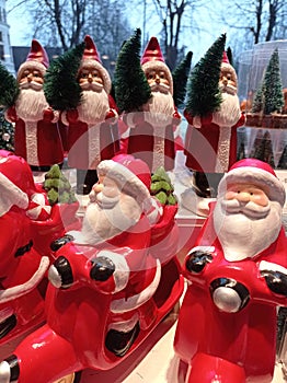 Santas riding the motorbikes and standing holding the christmas tree photo