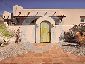 Sante Fe Style Home With Tile Walkway & Green Door photo