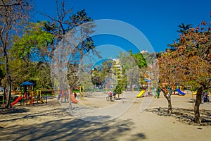 SANTIAGO, CHILE - SEPTEMBER 17, 2018: Unidentified blurred picture of people walking in the sandy playground at Forestal