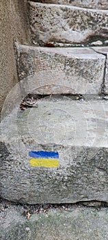 Santiago Compostela way marker on old limestone steps