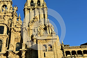 Cathedral with sunset light and clean stone. Obradoiro Square, Santiago de Compostela, Spain. Facade and tower details with statue photo