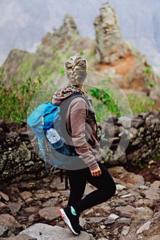 Santo Antao Island Cape Verde. Female tourist with blue backpack on hike enjoying view to Caculi valley from Corda photo