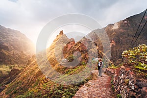 Santo Antao Island Cape Verde. Girl hiking along the trekking route to verdant Xo-Xo valley. Backlit by warm sunset