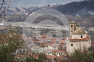 Santo Stefano Magra in Lunigiana area of Italy in La Spezia province. Church, houses and River Magra. Wintry day.