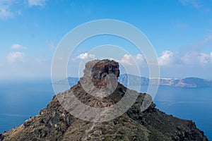 Santorini caldera view from the top of the hill. Blue sky and water.