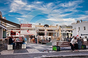 Tourists and locals at a food court at Fira city in Santorini island