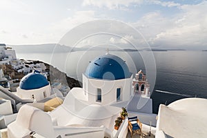 SANTORINI, GREECE - MAY 2018: Traditional Greek orthodox blue dome church on a sunny summer day. Cyclades Islands, Greece