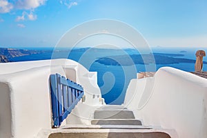 Santorini, Greece. Open blue door with Aegean sea view and Caldera.