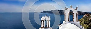 Santorini, Greece. Panorama of Greek Orthodox Church with bellfry in Oia village, aerial view
