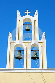 Santorini, Greece: traditional typical orthodox church with three bells.