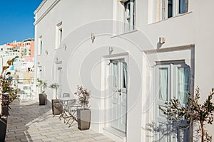 Santorini island Fira or Thera architecture. Traditional greek white hotel houses with empty cafe. Summer vacation