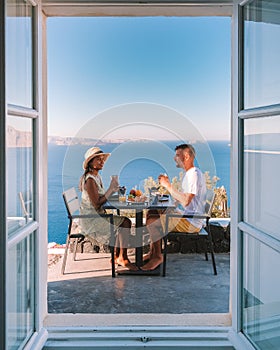 Santorini Island Greece, couple men and woman on vacation at the Greek Island of Santorini visit the white village of