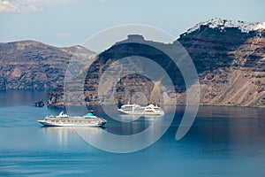 Santorini island, Greece. Cruise ships near the coast. Blue sea and the blue sky