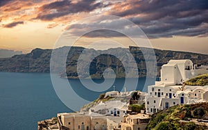 Santorini island, Greece. Oia caldera over Aegean sea, orange color cloudy sky, calm sea