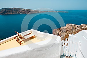 Santorini island, Greece. Two chaise lounges on the terrace with sea view