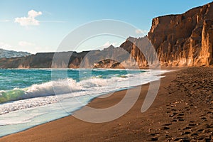 Santorini island, Greece. Vlichada beach with red volcanic pumice rocks