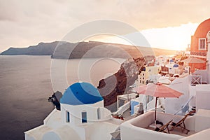 Santorini island Oia sunset landscape. Traditional white houses and church architecture with sea view. Travel to Greece