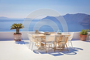 Santorini for relaxation. Greece, Santorini island, Oia - white architecture and deep blue. Table and chairs on the terrace. Greek