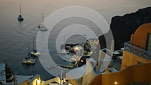 Santorini sea bay with yachts in the evening. Catamarans moored in a bay on Santorini