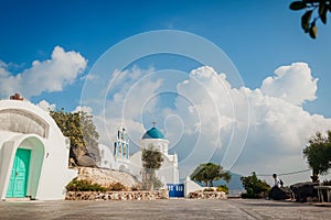 Santorini traveler exploring discovering greek church architecture in Akrotiri. Man hiker having rest. Vacation