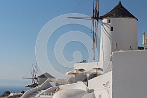 Santorini urban landscape with white windmills