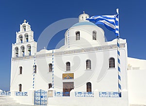 Santorini white church with blue dome and bell tower in Oia, Greece landmark