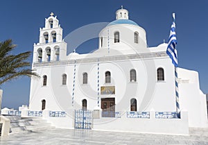 Santorini white church with blue dome and bell tower in Oia, Greece landmark