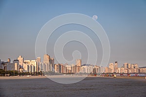 Santos Beach and city skyline at sunset with full moon - Santos, Sao Paulo, Brazil