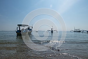 Sanur, Bali, Indonesia - February 7, 2021: Sanur beach in the morning. The activities of anglers and fishermen. Fishing boats
